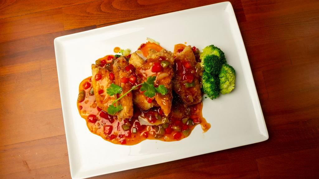Pla Rad Prik · Double spicy. Fish fillet, spicy garlic sauce, bell peppers, and steamed broccoli.