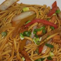 Tallarin Saltado De Pollo · Homemade Peruvian stir-fried linguine sautéed with strips of chicken and red bell peppers in...