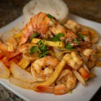 Saltado De Camarones · Traditional Peruvian stir-fry, with shrimps, red onions, and tomatoes. Served with French fr...