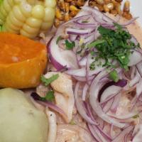Ceviche De Pescado · Fresh sliced fish fillet marinated in lime juice and infused with red onions. Accompanied wi...