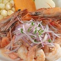 Ceviche De Camaron · Fresh shrimps marinated in lime juice; infused with red onions. Accompanied by Inca corn, po...