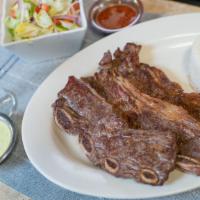 Costillas A La Parrilla · Grill ribs served , with rice and salad