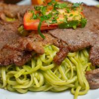 Tallarin Verde Con Bistek · Tender seasoned steak on a pesto linguine, mixed with basil and spinach cream, accompanied w...