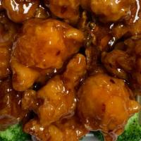 Orange Flavor Chicken · Chunks of fried crispy chicken on hot orange sauce. With white rice. Hot and spicy.