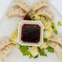 House Dumplings · Eight thin Chinese wrappers filled with shrimp and vegetables, steamed or pan fried.