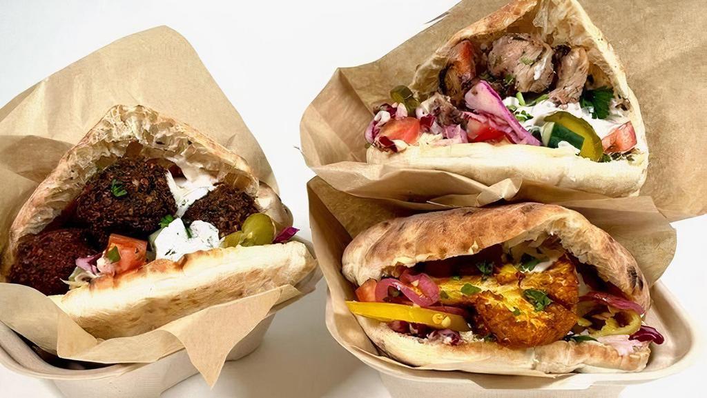 Pita · Freshly baked artisan pita stuffed with hummus, israeli salad, pickled cabbage, tahini & your choice of main.  Add toppings & sauces to customize it!