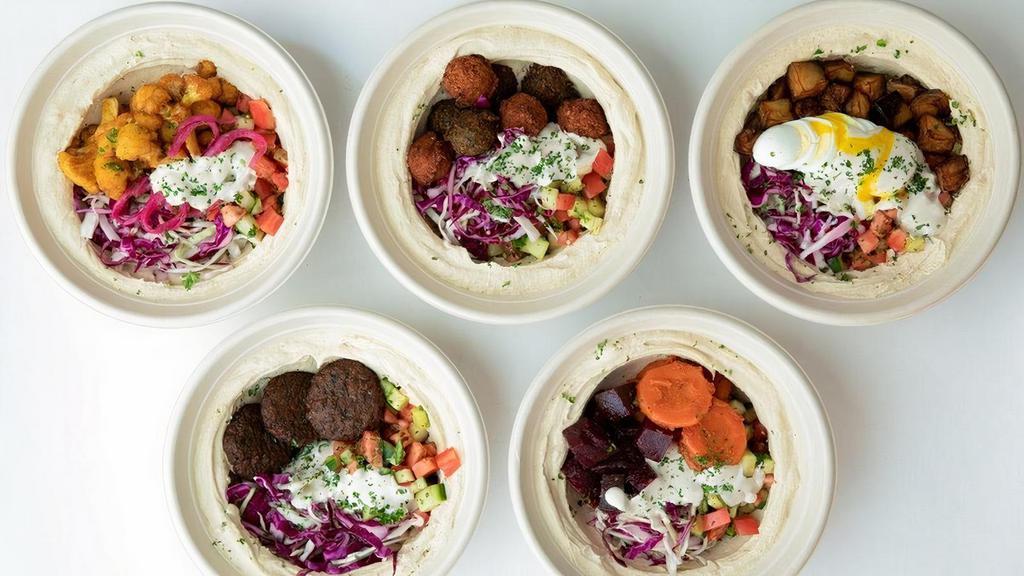 Bowl · Choose your bowl base of creamy hummus, turmeric pearl couscous, toasted cumin rice or romaine lettuce (or choose a combo of 2 bases) served over israeli salad, pickled cabbage, tahini and your choice of main. Add toppings & sauces to customize it!