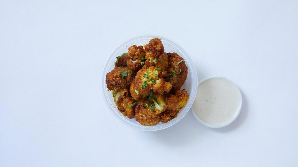 Cauliflower Side · Crispy, golden cauliflower tossed in our special shawarma spice blend. Served with creamy tahini sauce.