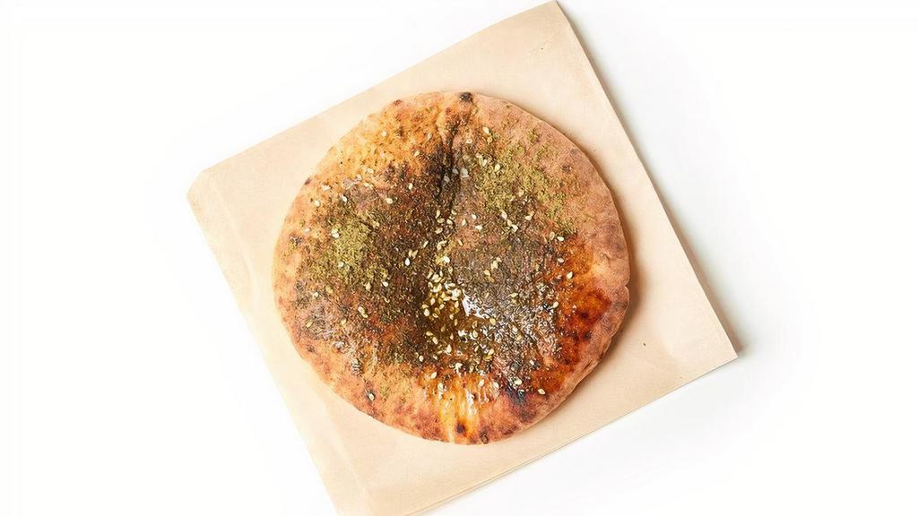 Side Pita · A freshly baked pita brushed with olive oil and za'atar spice. Choose white or wheat.