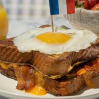 Le Bacon, Egg, And Cheese French Toast Sandwich · Get ready to be “le stuffed.” Bacon, fried egg, and cheddar cheese sandwiched between 2 slic...