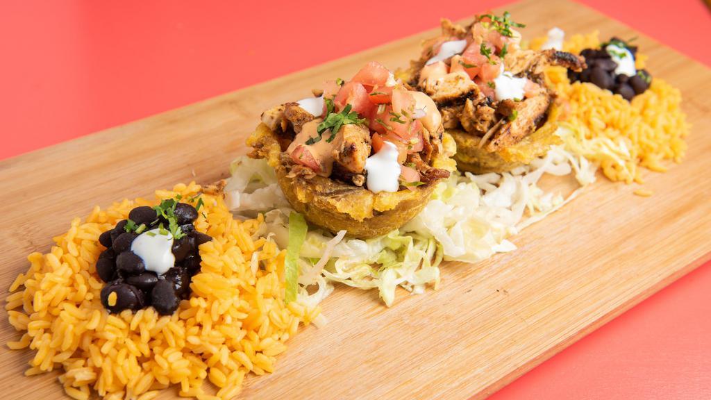 Mofonguito · Two stuffed plantain cups with your favorite meats topped with pico de gallo mexicrema cilantro chipotle salsa served with rice and beans.