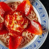 Halibut Red Star Noodles · Steamed halibut with rice noodles and pickled vegetables in a mild spiced broth.