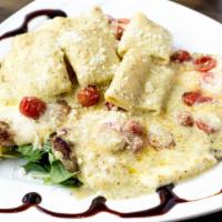 Pollo Sfizioso · Chicken cutlet, homemade mozzarella, baby arugula, cherry tomatoes, and pesto sauce. No pasta.