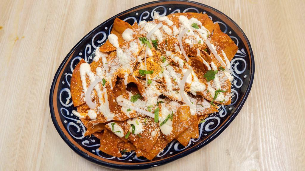 Chilaquiles Verdes O Rojos · Tortilla chips cooked with choice of red or green sauce, topped with Mexican cream, fresh cheese and red onion.