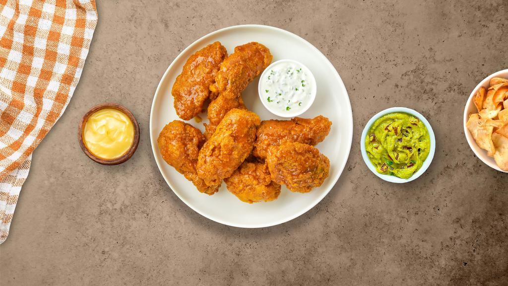 Mango Tango Habanero Wings · Fresh chicken wings breaded, fried until golden brown, and tossed in mango habanero sauce. Served with a side of ranch or bleu cheese.