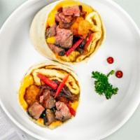 Pass The Pastrami Breakfast Burrito · Pastrami, eggs, cheddar cheese, tomatoes and onions wrapped in a flour tortilla.