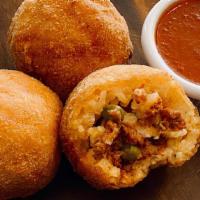 Rice Ball · Served with a side of marinara sauce.