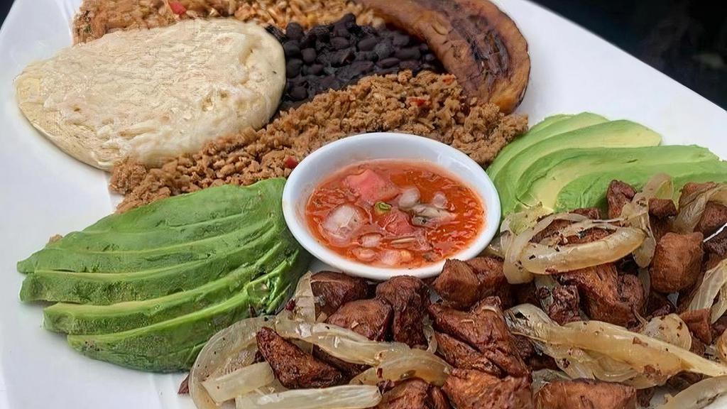 Bandeja Paisa - Colombia'S National Dish! · A traditional Colombian variety plate with crispy Blackbird chicharron, ground carne 