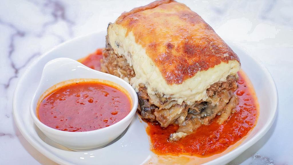 Moussaka · Layers of eggplant, potatoes & ground beef topped with béchamel sauce