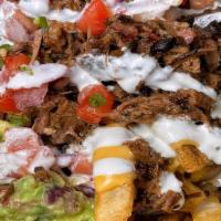 Loaded Mexican Street Fries · Skin-on fries, queso, chopped brisket, guacamole, pico de gallo, jalapeños, and sour cream.