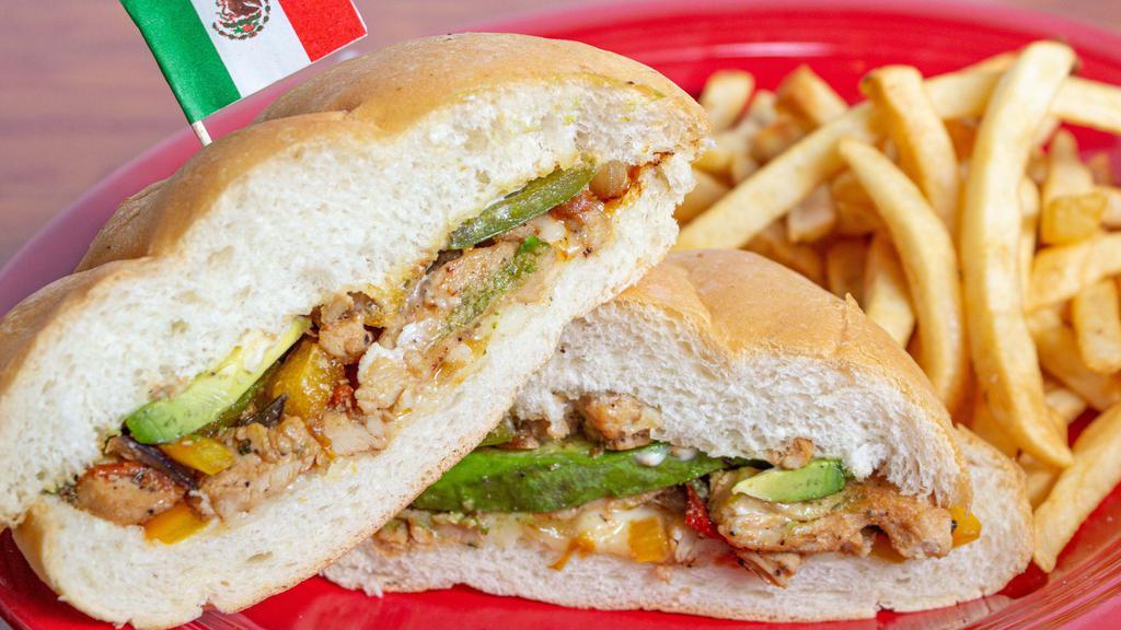 Mexican Torta · Chicken, steak, and chicken a la milanesa on a toasted mexican roll with guacamole, mayonnaise, onions, sour cream, lettuce, tomato, refried beans, and cheese.