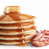 Bacon Buttermilk Pancakes · 3 perfectly fluffy pancakes topped with crispy bacon served with a side of butter and syrup.