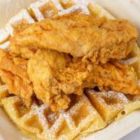 Plain Chicken & Waffle · Three fried tenders with one large waffles that is  garnished with powdered sugar syrup on t...