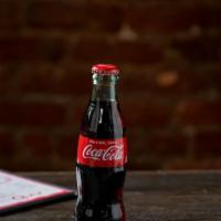Cocca Cola · Coca cola in a glass bottle.