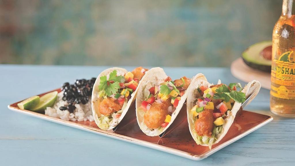 Fish Tacos · Fish Tacos
Crisply fried in LandShark batter wrapped in a grilled flour tortilla and layered with grilled habanero cream sauce, fresh guacamole, shredded lettuce and mango pico de gallo. Served with black beans and rice
1860 Cal.