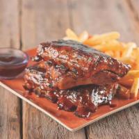 Bbq Ribs · Fork tender baby back ribs seasoned and basted with signature BBQ sauce served with french f...