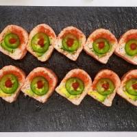 Pink Lady Roll · (Pink soy bean paper)
In: spicy tuna, avocado, cucumber, kani
Top: jalapeno, Sriracha sauce