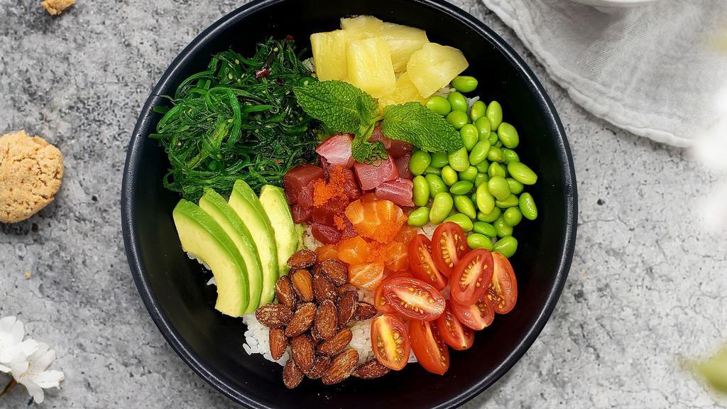 Rainbow Poke Bowl · Salmon, tuna, yellowtail, seaweed salad, edamame, avocado, tomato, pineapple, almond, masago, scallions, poke sauce.