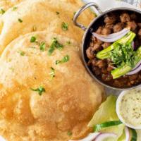 Chole Bhature (2 Pcs) · Fried flat bread (2pcs) made with all purpose flour, served with boiled Chickpeas (Chole) co...