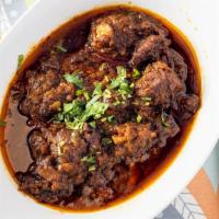 Goat Curry · Halal Mutton cooked in Onion and Tomato gravy.