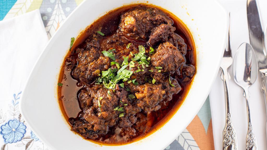 Goat Curry · Halal Mutton cooked in Onion and Tomato gravy.