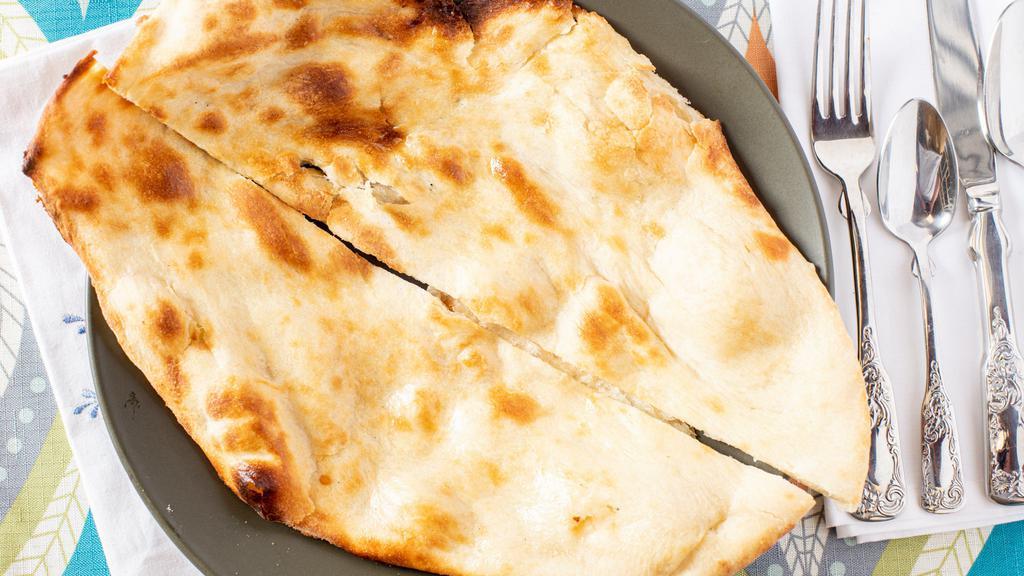Plain Naan · Flat bread (eggless) made of all purpose flour, baked in Tandoor.
