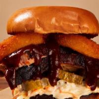 Brisket Sandwich · Slow smoked brisket topped with pickle, onion rings, coleslaw and our house BBQ sauce