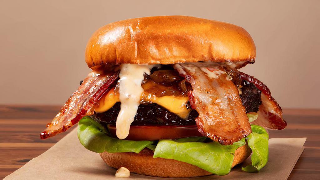 Remy'S Bacon Cheeseburger · Premium short rib burger with American Cheese, Bacon, Caramelized onions Lettuce and tomato, house sauce, mustard and ketchup on toasted brioche bun.