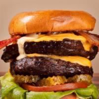 Double Trouble Burger · 2 Premium short rib burger patties topped with Triple American cheese, grilled onions, lettu...