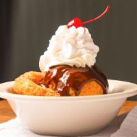 Fried Ice Cream · French vanilla ice cream deep-fried in a crunchy honey coating. Topped with whipped cream an...