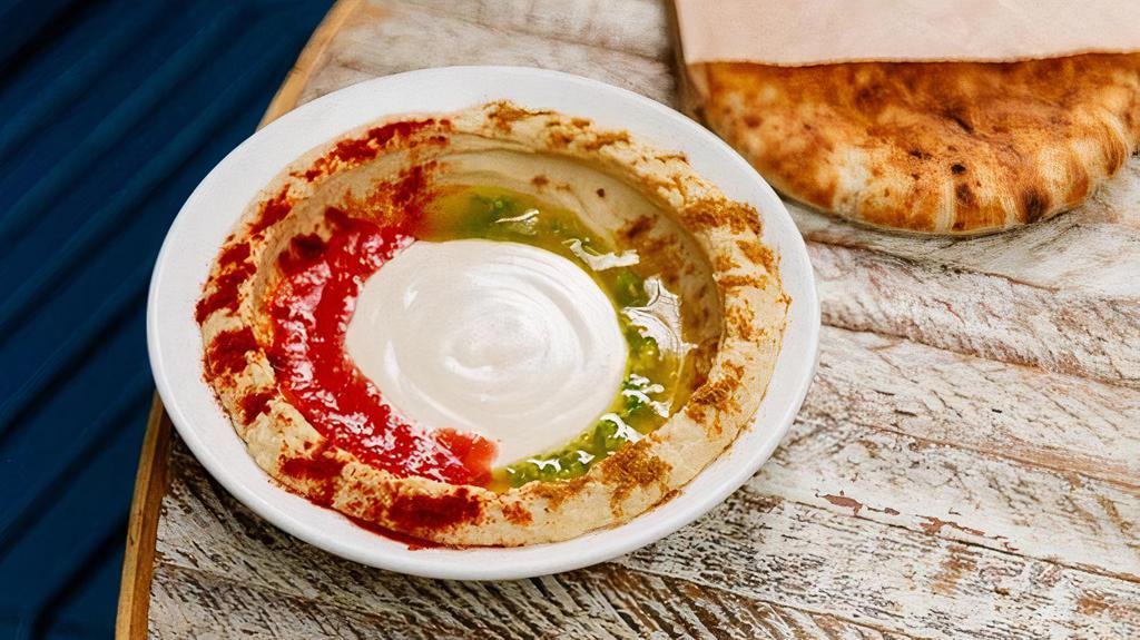 Hummus · Small Hummus with tahini, grated tomato & chili oil.  Served with 1 pita.  . *It's gluten-free when ordering with gluten-free pita.. *If sharing, recommended to add extra pita.