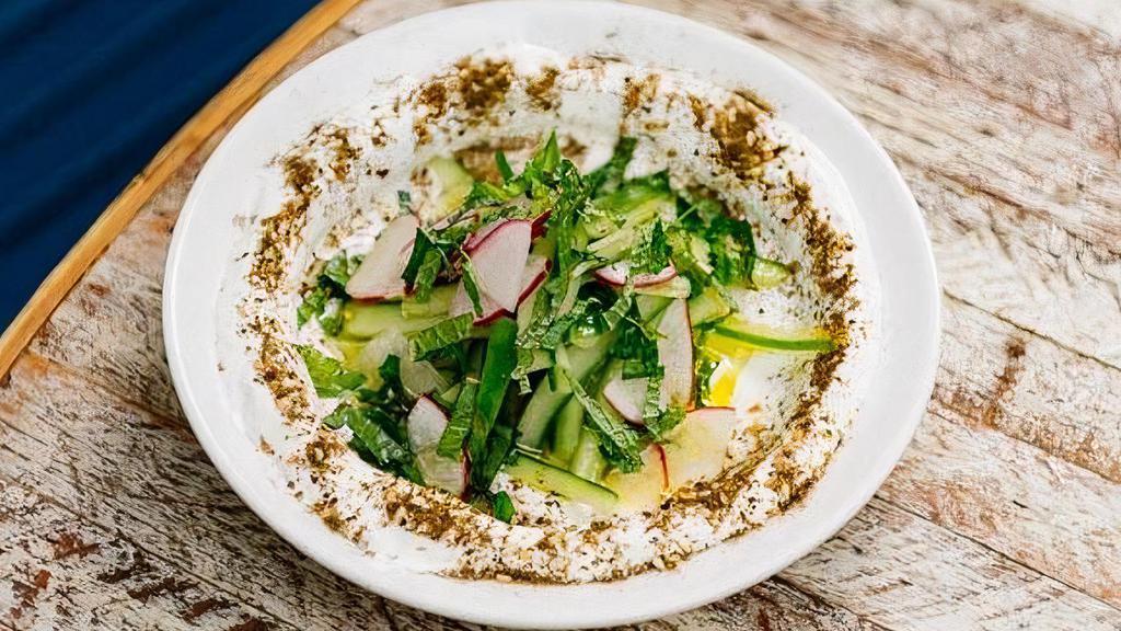 Labneh · Small Arabic strained yogurt topped with persian cucumber, radish, mint, olive oil and zahtar.  Served with 1 pita.. * It's gluten-free when served with gluten-free pita.. *If sharing, recommended to add extra pita.