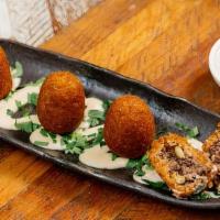 Beef Kibbeh (4 Pcs) · bulgur wheat shell kibbehs filled with ground beef and pine nuts. (4 Pieces)