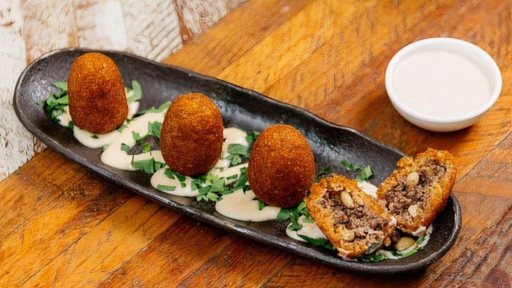 Beef Kibbeh (8 Pcs) · bulgur wheat shell kibbehs filled with ground beef and pine nuts. (8 Pieces)