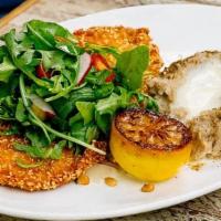 Schnitzel · Thinly pounded chicken breast breaded in panko & sesame seeds, served with arugula salad & z...