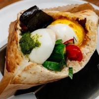 Sabich / Pita · Classic Iraqi-Israeli Street Food Sandwich. Eggplant, hard boiled egg, hummus, amba, green s...