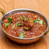 Rogan Josh · Lamb cubes cooked with tomatoes in freshly ground spices and yogurt sauce.