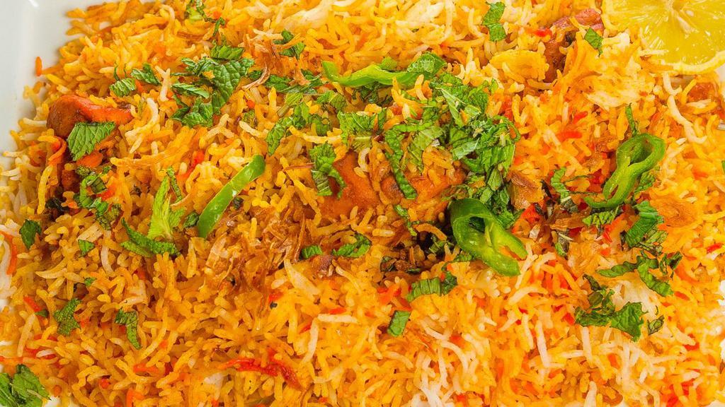 Chicken Biryani · A classic mughlai specialty made with basmati rice cooked with chicken.