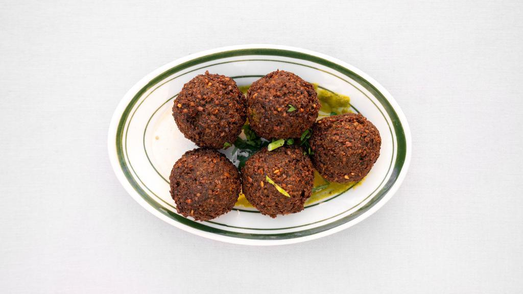 Falafel · Vegan. Five falafel balls served on tahini and green sauce.