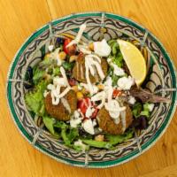 Falafel Salad · With cherry tomatoes, cucumbers, red onions, chickpeas and feta cheese, with lemon and extra...